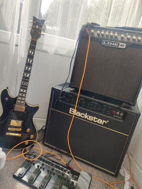 Carl's electric guitar, two amplifiers and a pedalboard